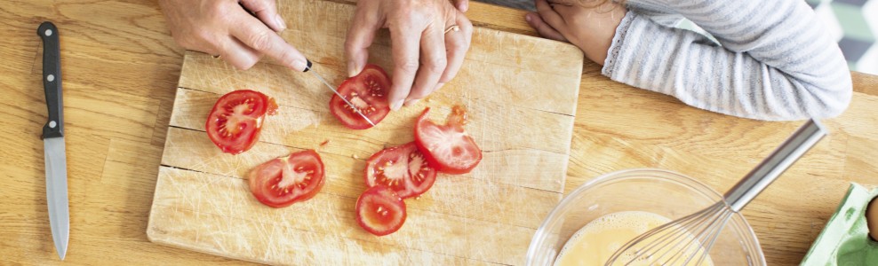Slicing tomatoes on a cutting board.