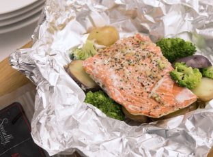 Healthy Salmon foil packet with potatoes and broccoli.