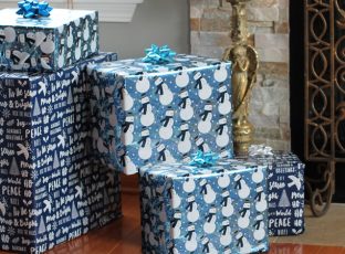 Wrapped gifts in front of a fireplace.